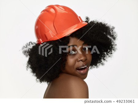 Portrait of confident female worker in orange helmet Portrait of confident female worker in orange helmet 49233061