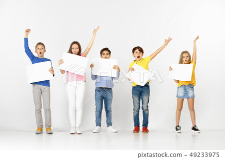 Group of children with a white banners isolated in white Group of children with a white banners isolated in white 49233975