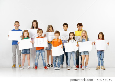 Group of children with a white banners isolated in white Group of children with a white banners isolated in white 49234039