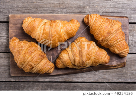 Croissants on wooden background 49234186