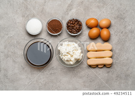 Ingredients for cooking tiramisu - Savoiardi biscuit cookies, mascarpone, cheese, sugar, cocoa Ingredients for cooking tiramisu - Savoiardi biscuit cookies, mascarpone, cheese, sugar, cocoa 49234511