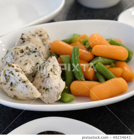 Boiled vegetables in a plate with meat. Boiled vegetables in a plate with meat. 49234641