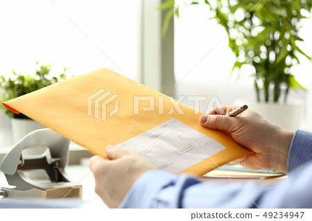 Businessman hold hand yellow mail envelope 49234947