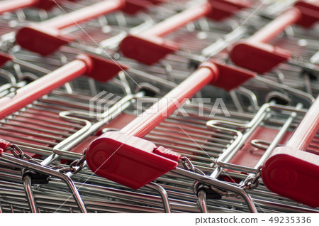 closeup of red supermarket trolleys alignment 49235336