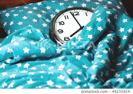Big wall clock in a blue bed 49235824