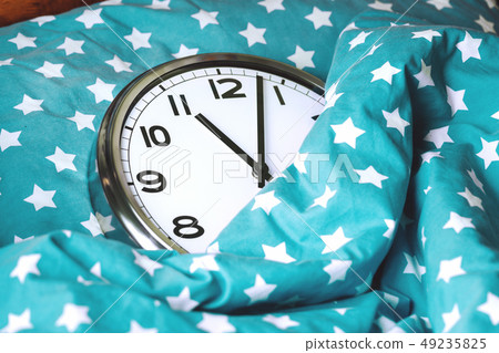 Big wall clock in a blue bed 49235825