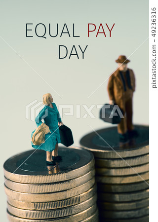 miniature woman and man and text equal pay day 49236316