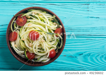 Zucchini pasta noodles with tomatoes . Healthy 49236602