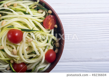 Zucchini pasta noodles with tomatoes . Healthy 49236604