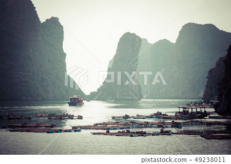 Rock islands near floating village in Halong Bay, 49238011