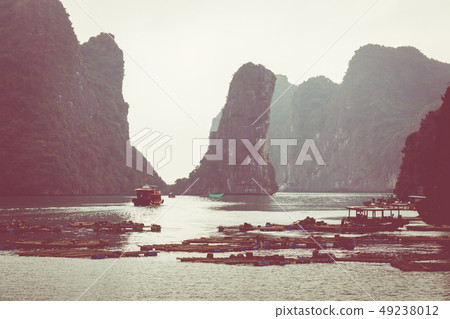 Rock islands near floating village in Halong Bay, 49238012