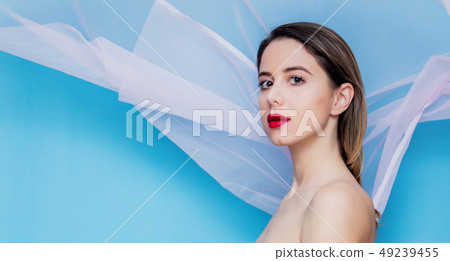 Young woman with pink tulle on blue background 49239455