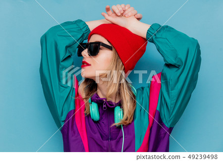 woman in red hat, sunglasses and suit of 90s with headphones woman in red hat, sunglasses and suit of 90s with headphones 49239498