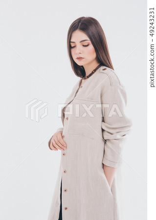 beautiful girl in long linen coat on white beautiful girl in long linen coat on white 49243231