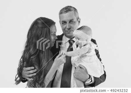 baby on the hands of parents on a white 49243232