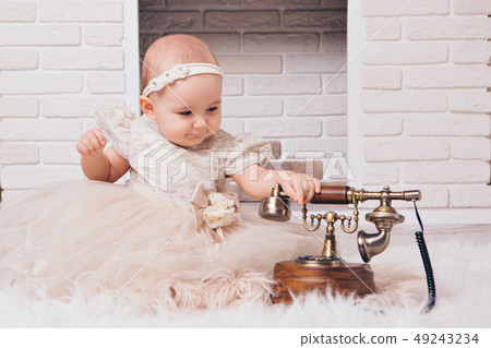 a little girl in a white dress sitting by the a little girl in a white dress sitting by the 49243234