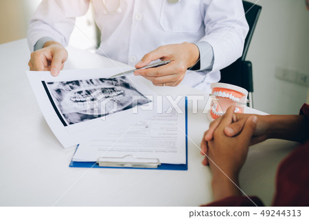 Dentists are discussing dental problems at report Dentists are discussing dental problems at report 49244313
