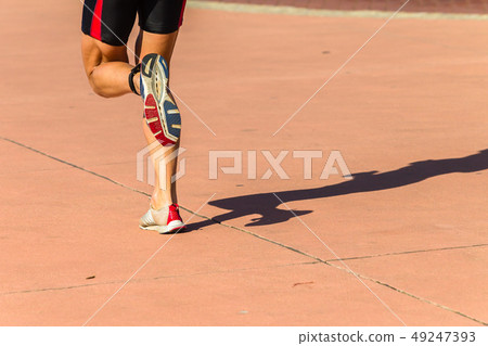 Athlete Running Rear Feet Shoes Closeup Athlete Running Rear Feet Shoes Closeup 49247393