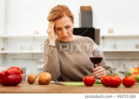 Upset good-looking lady with tied hair wearing warm beige sweater 49255166