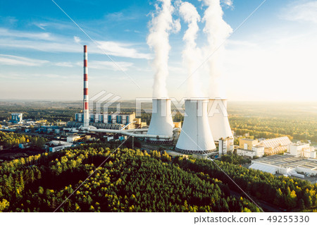 A Power plant with white smoke over it's chimneys A Power plant with white smoke over it's chimneys 49255330