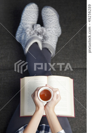 Young woman reading a book Young woman reading a book 49256289
