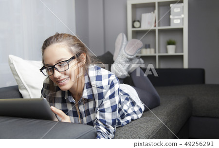 Using Digital Tablet on Sofa Using Digital Tablet on Sofa 49256291