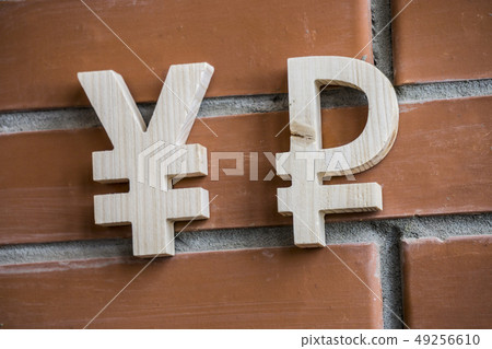 Exchange rate. Wooden yuan or yen and broken ruble symbol on brick wall background 49256610