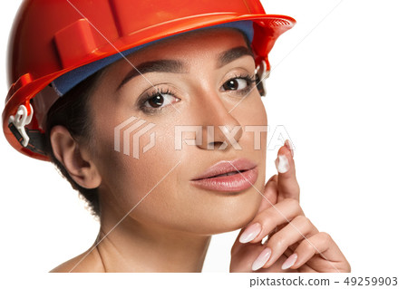 Portrait of confident female worker in orange helmet 49259903