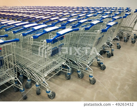 Rows of shopping carts collected in supermarket. Rows of shopping carts collected in supermarket. 49263432