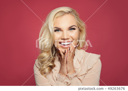 Portrait of laughing woman on pink background. 49263676