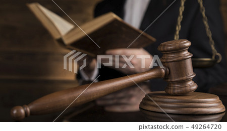 Judge, male judge in a courtroom striking the 49264720