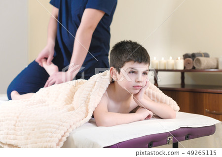 Little boy patient at reception at a professional masseuse. Foot Massage Therapy 49265115