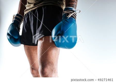 Boxers figure wearing blue boxing gloves and shorts Boxers figure wearing blue boxing gloves and shorts 49271461