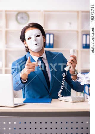 Male employee in the office in industrial espionage concept    49271718