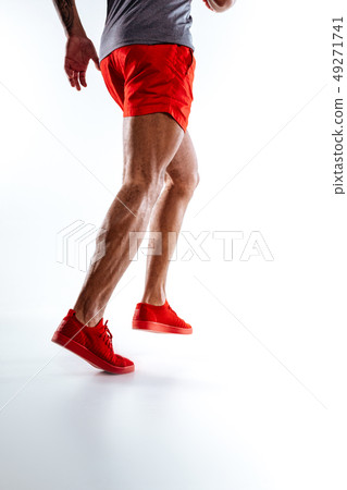 Mans figure wearing red shorts performing running movements Mans figure wearing red shorts performing running movements 49271741