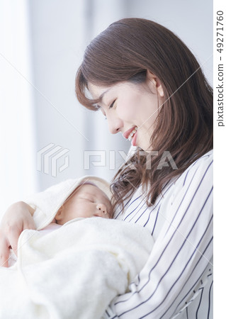 Mother holding a baby 49271760