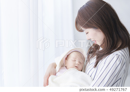 Mother holding a baby Mother holding a baby 49271767