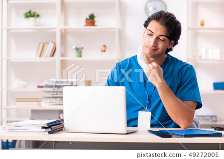 Young handsome doctor working in the clinic  49272001