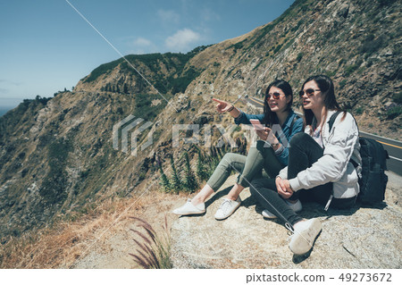 girl hiker holding phone showing pacific ocean girl hiker holding phone showing pacific ocean 49273672