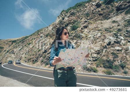 hiker pick up local paper map looking hiker pick up local paper map looking 49273681