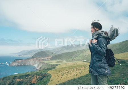 girl backpacker with scarf flying in wind girl backpacker with scarf flying in wind 49273692