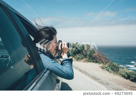 tourist taking photo during car road trip tourist taking photo during car road trip 49273695