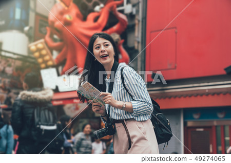 smiling gril standing in front of takoyaki vendor 49274065