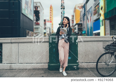 girl traveler with camera holding map searching 49274068