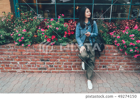 girl rely on flower nursery made of red brick 49274150