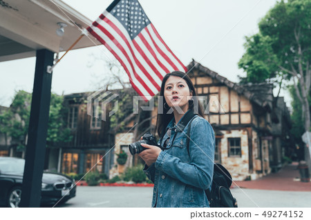 traveler holding professional camera standing 49274152