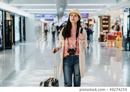 woman walking through the duty free zone woman walking through the duty free zone 49274259