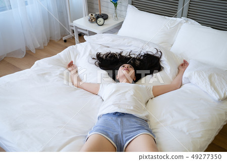 gloomy girl resting on bed in bad mood. gloomy girl resting on bed in bad mood. 49277350