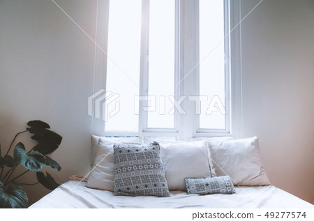 Interior Cozy bedroom in the morning and pillows. Interior Cozy bedroom in the morning and pillows. 49277574