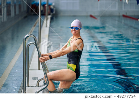 Portrait of a smiling woman swimmer  49277754